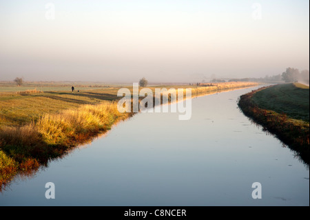 The old Bedford Level or River in the Fens near Cambridge, Cambridgeshire on a misty moning Stock Photo
