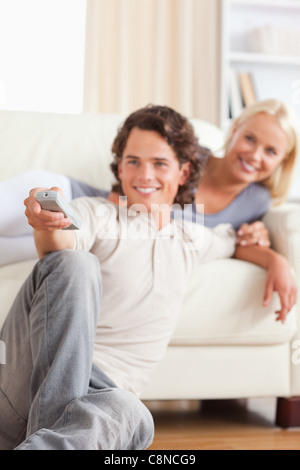 Portrait of a couple watching the television Stock Photo