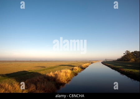 The Old Bedford Level Drain or river in the Fens Cambridgeshire on a misty autumnal morning Stock Photo