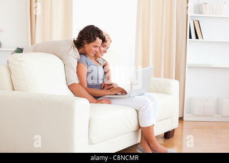 Smiling young couple using a notebook Stock Photo