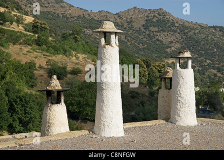 Spain, Andalucia, Alpujarras, Capileira, Chimneys near mountain Stock Photo