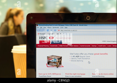 The HSBC website shot in a coffee shop environment (Editorial use only: print, TV, e-book and editorial website). Stock Photo