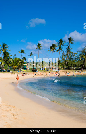 Sunny day at Poipu beach with white sand beach and palm trees, Kauai Stock Photo