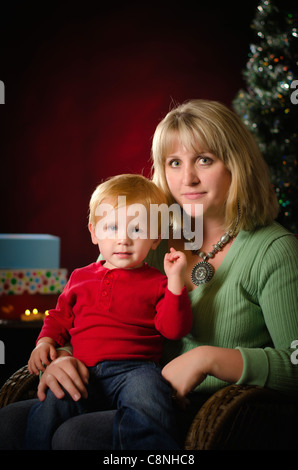 Mother and little son in front of Christmas decoration Stock Photo