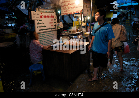 Thais still selling their goods & doing business during the flood, Tha Chang Pier, Chao Phraya River, Bangkok, Thailand. Oct., 2011. credit: Kraig Lieb Stock Photo