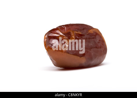 Single dried date fruit from low perspective with shallow focus. Stock Photo