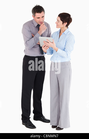 Office workers looking at a tablet computer Stock Photo