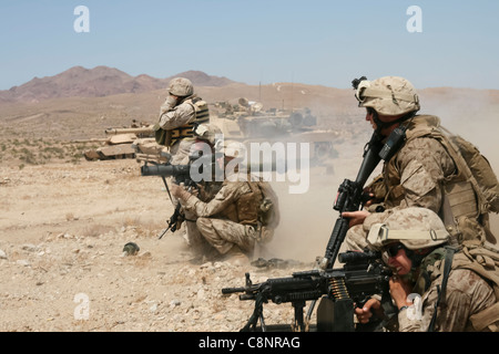 Supported by M1A1 Abrams tanks from 1st Tank Battalion, 1st Marine Division, the infantrymen of 2nd Platoon, Company F, 2nd Battalion, 25th Marine Regiment, assault an enemy objective during a live-fire combined arms exercise Aug. 14 at Marine Corps Air Ground Combat Center in Twentynine Palms, Calif. Stock Photo