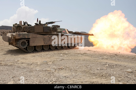 A M1A1 Abrams battle tank from Tank platoon Alpha Company, Battalion Landing Team 1st Battalion, 9th Marine Regiment, 24th Marine Expeditionary Unit, discharges a 120mm round towards a tank hull during a live-fire range in Djibouti, Africa March 30. Marine tank crewmen engaged various targets alongside the French 13th Foreign Legion Demi-Brigade as part of a joint exercise. The 24th MEU is currently serves as the theatre reserve force for Central Command during its seven month deployment aboard Nassau Amphibious Ready Group vessels. Stock Photo