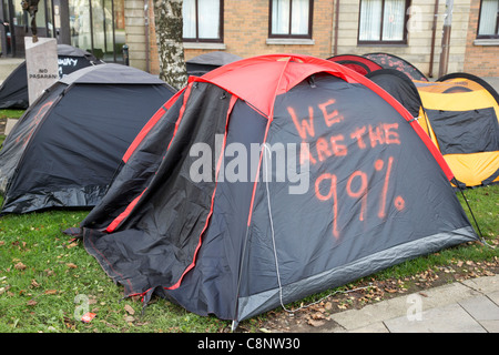 We are the 99% occupy belfast anti capitalist tented protest in writers square belfast northern ireland uk Stock Photo