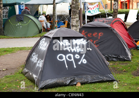 We are the 99% occupy belfast anti capitalist tented protest in writers square belfast northern ireland uk Stock Photo