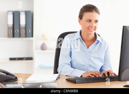 Office worker typing on a keyboard Stock Photo