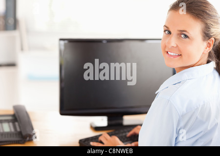Office worker using her computer Stock Photo