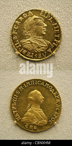 Russian gold coins from the numismatic collection of the Bode Museum in Berlin, Germany. Gold two roubles coin of Russian tsar Peter the Great from 1729 (top) and gold half imperial (five roubles) coin of Russian tsar Peter III from 1762 (down) are seen in the picture. Stock Photo