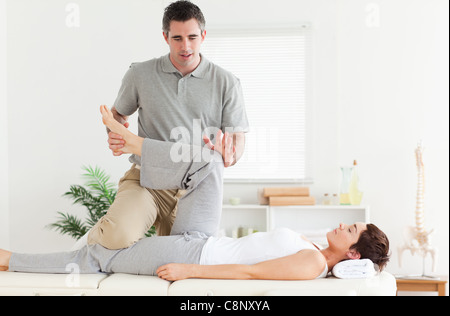 Chiropractor stretching a woman's leg Stock Photo