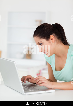 Cute young woman focused on laptop Stock Photo
