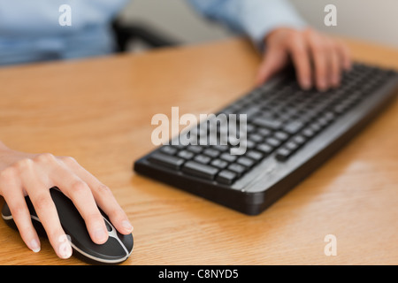 businesswoman with hands on mouse and keyboard Stock Photo