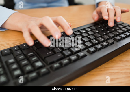 Woman typing on keyboard Stock Photo