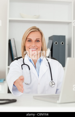 Smiling doctor giving hand Stock Photo