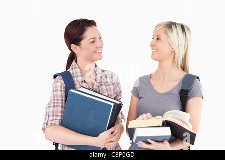 Students with books looking at each other Stock Photo