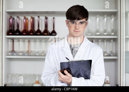 Male science student writing on a clipboard Stock Photo