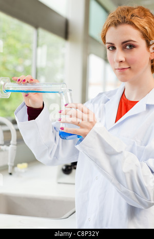 Portrait of a cute scientist pouring liquid Stock Photo