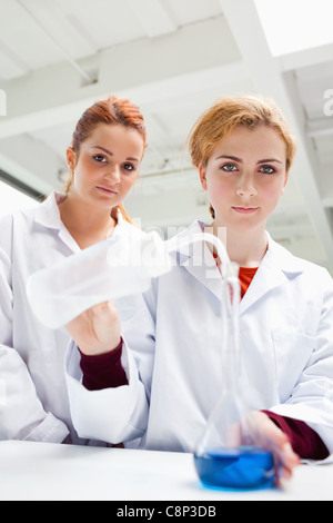 Portrait of cute science students doing an experiment Stock Photo