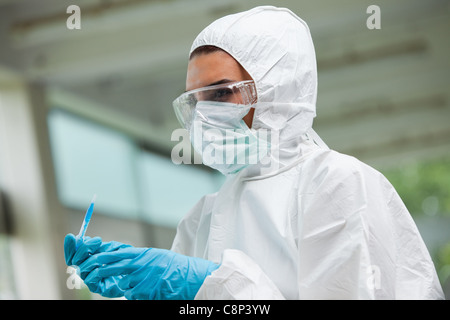 Protected science student posing with dangerous liquid Stock Photo