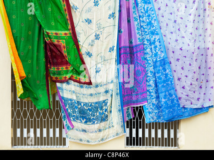 Colourful indian saris hanging out to dry outside a rural indian home. Andhra Pradesh, India Stock Photo