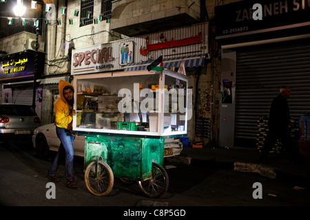 Man pushing a decorated cart with figure of a Paletinian militant in Ramallah a Palestinian city in the central West Bank in the Palestinian territories