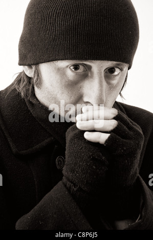 Homeless man in the cold, monochromatic image. Stock Photo