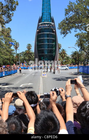 Crowds of people behind a barricade take photographs of The Queen's Range Rover as it passes the Bell Tower in Perth, Australia Stock Photo