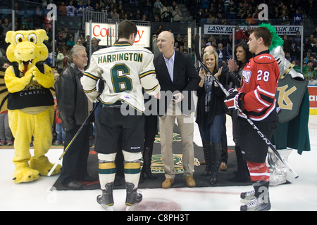 London Ontario, Canada - October 28, 2011. Former Toronto Maple Leaf captain Mats Sundin speaks with Scott Harrington (6) of the London Knights after dropping the puck prior to the game. London won the game in overtime 3-2. Stock Photo