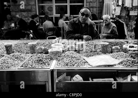 Standing in front of a spice stand in the market, dreaming with sunglasses. Stock Photo