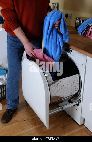 Andrew Reason with his energy saving Reason front loading washing machine UK Stock Photo