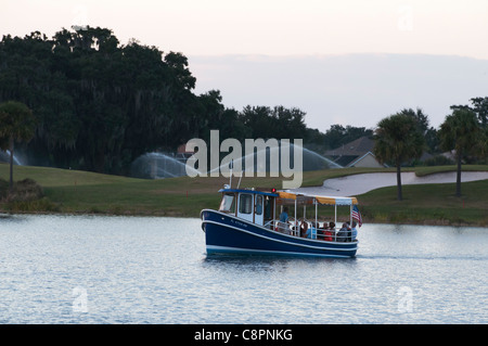 Lake Sumter Landing Tour boat on Lake Cherry located in The Villages, Florida a  golf retirement community for 55 and above. Stock Photo