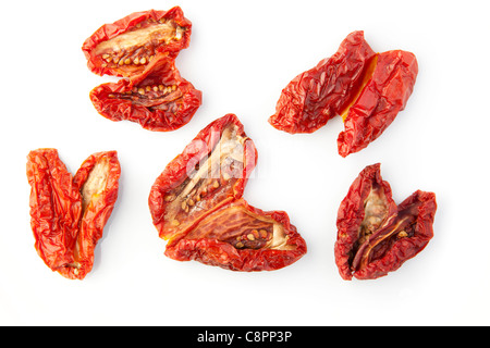 Five sun dried tomatoes on a white background Stock Photo