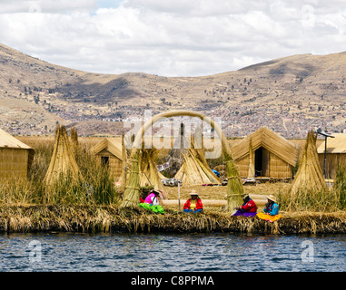 Women wearing traditional peruvian costume Uros island Titicaca lake Puno Peru Stock Photo