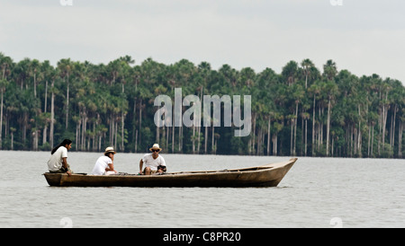 Tourists accompanied by Peruvian guide on a boat Sandoval lake Tambopata National Reserve Puerto Maldonado Amazon Area Peru Stock Photo