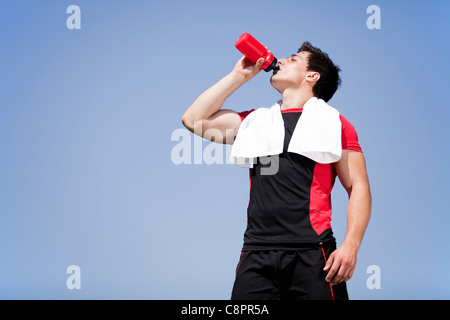 Tired athlete refreshing him self with fresh water Stock Photo