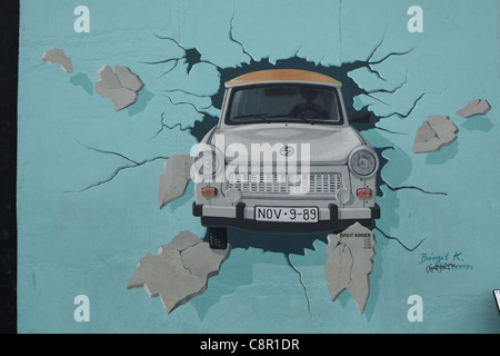 Trabant breaking through the wall pictured on the Berlin Wall in East Side Gallery in Berlin, Germany. Stock Photo