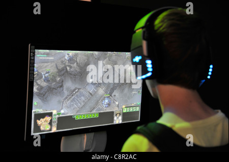 male teenager plays Computer role-playing game at the gamescom convention in Cologne, Germany Stock Photo