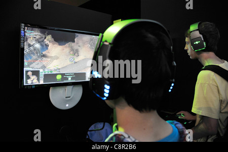 male teenagers play Computer role-playing game at the gamescom convention in Cologne, Germany Stock Photo