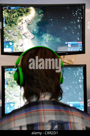 male teenager plays Computer role-playing game at the gamescom convention in Cologne, Germany Stock Photo