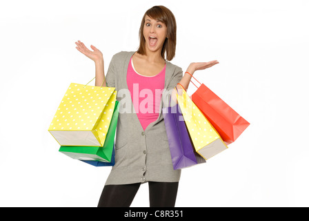 Pretty Young Woman With Excited Expression, Holding Many Bright Colored Shopping Bags Stock Photo