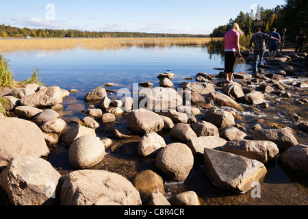 The Mississippi headwaters at Lake Itasca State Park in northern Minnesota are easily crossed via large rocks. Stock Photo