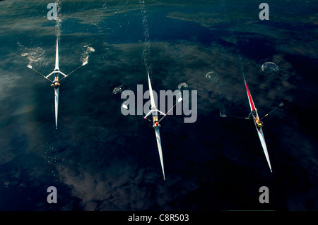 People rowing sculling boats on river Stock Photo