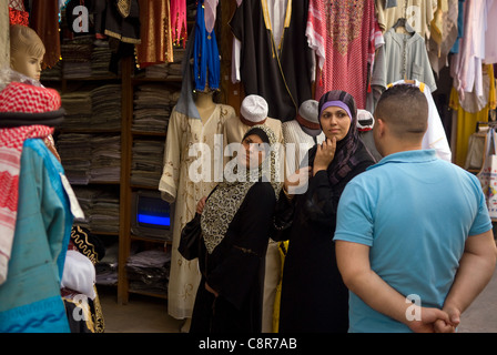 Arab women shopping in the Khan al-Khayyatin or tailors's khan, souk, old city, Tripoli (Trablous), northern Lebanon. Stock Photo