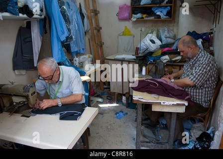 Men at work in the Khan al Khayattin or Tailor's Khan, old city, Tripoli, northern Lebanon. Stock Photo