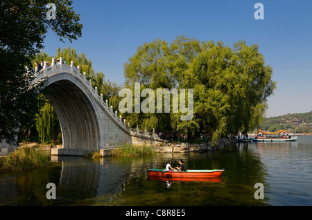 Couple rowing under the Jade Belt Bridge on Kunming Lake Summer Palace Beijing Peoples Republic of China Stock Photo